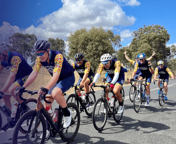 A group of cyclists riding together in Mental Wheels Foundation jerseys