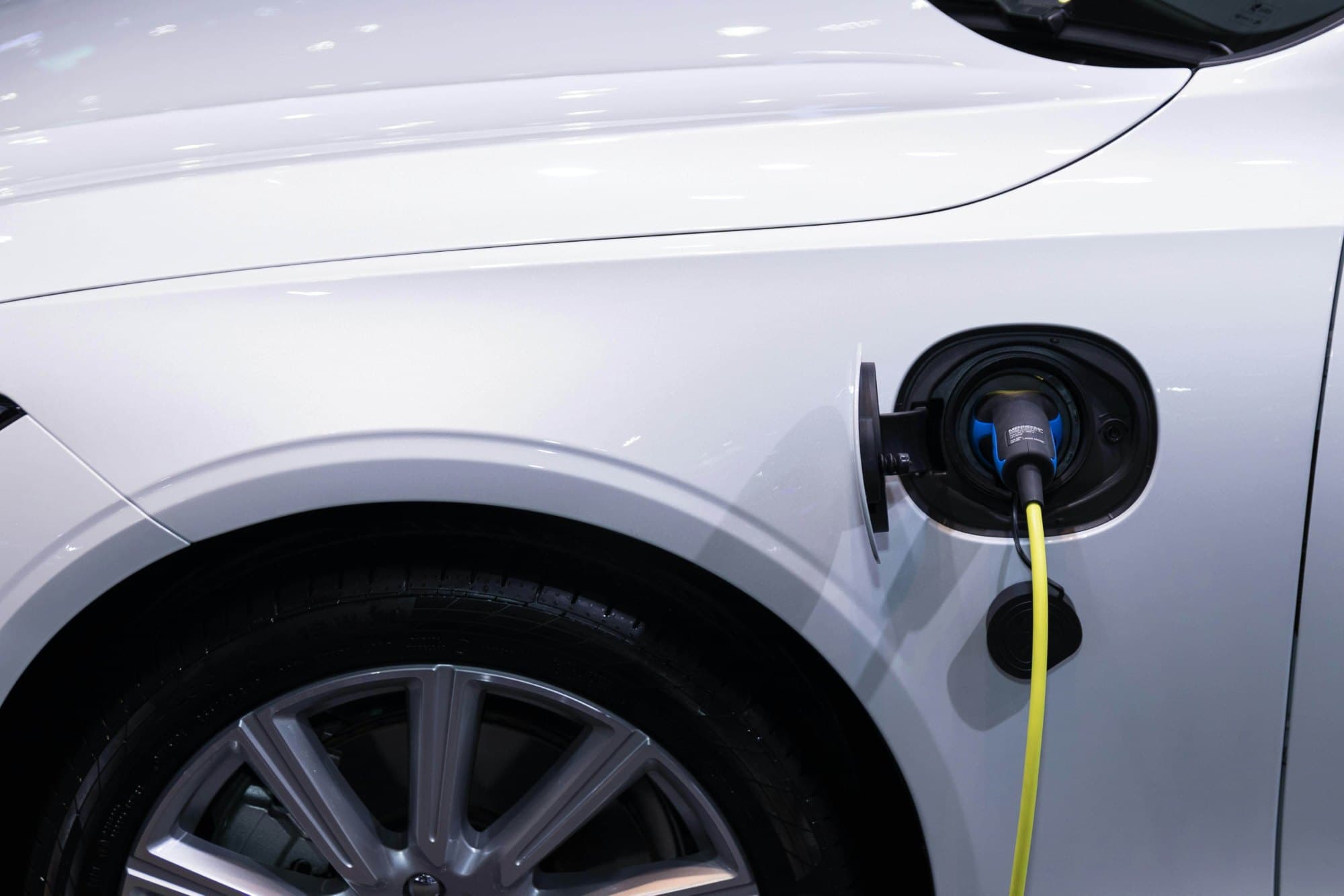 An electric car plugged in and charging at a home charging point