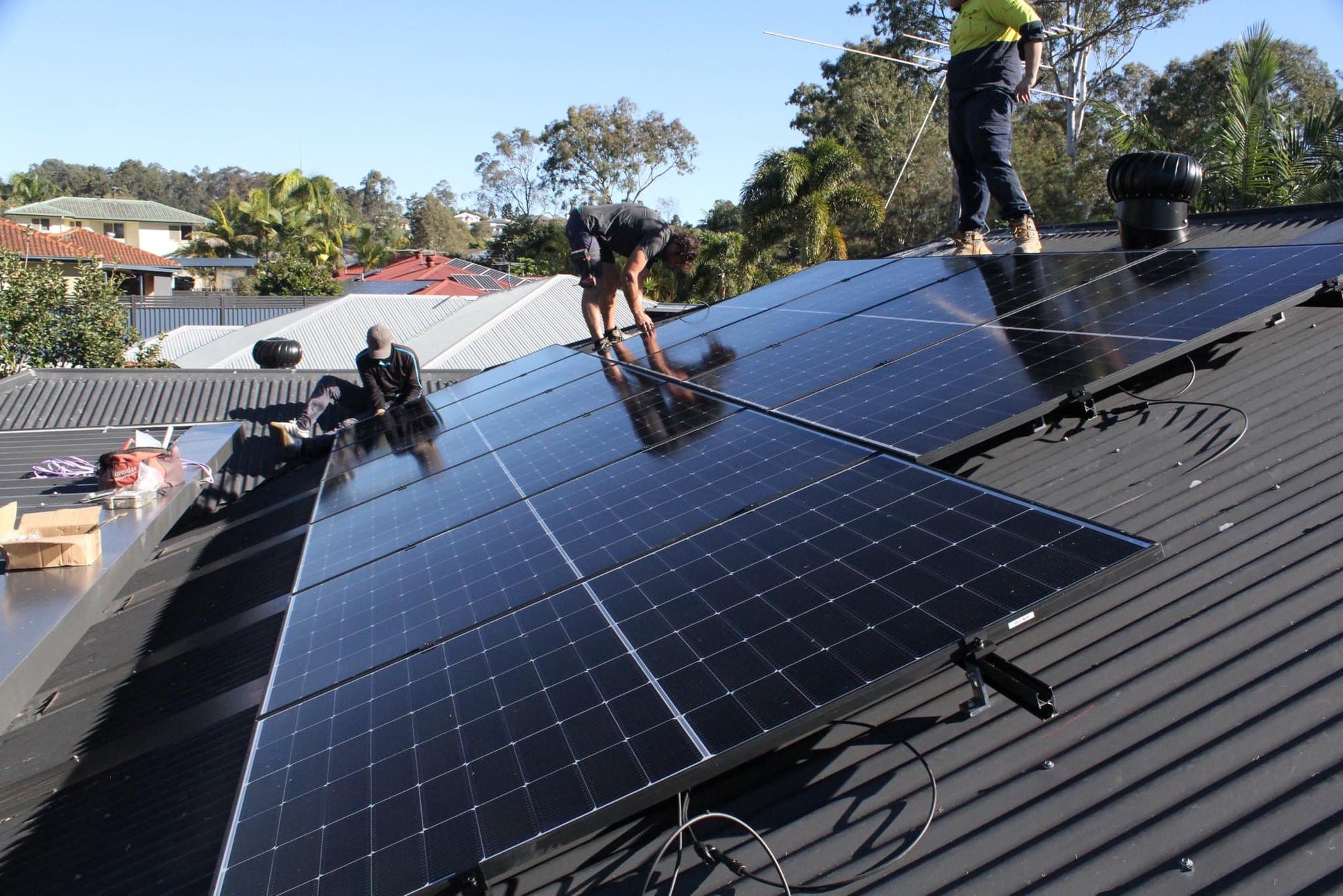Solar panels being installed on the tiled roof of a Queensland home