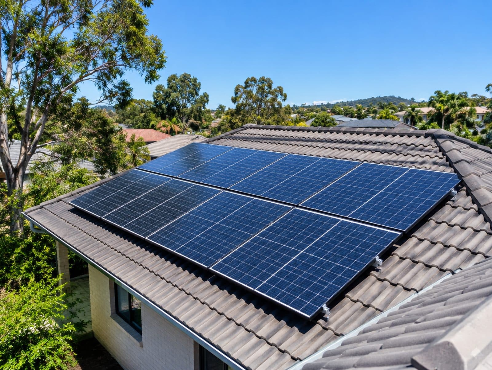 Solar panels being laid onto a tiled Brisbane roof