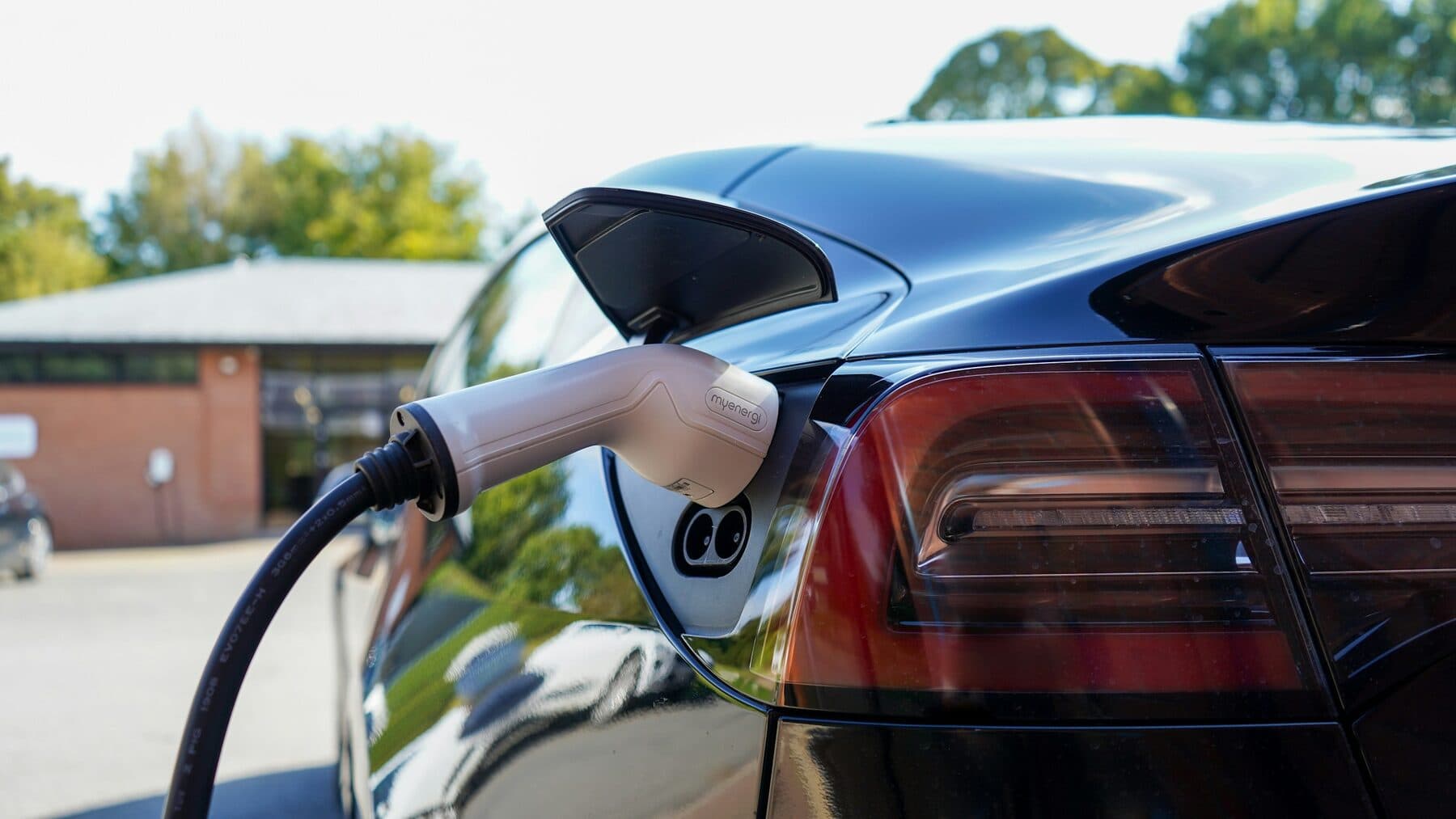 Home EV charger plug connected to an electric car