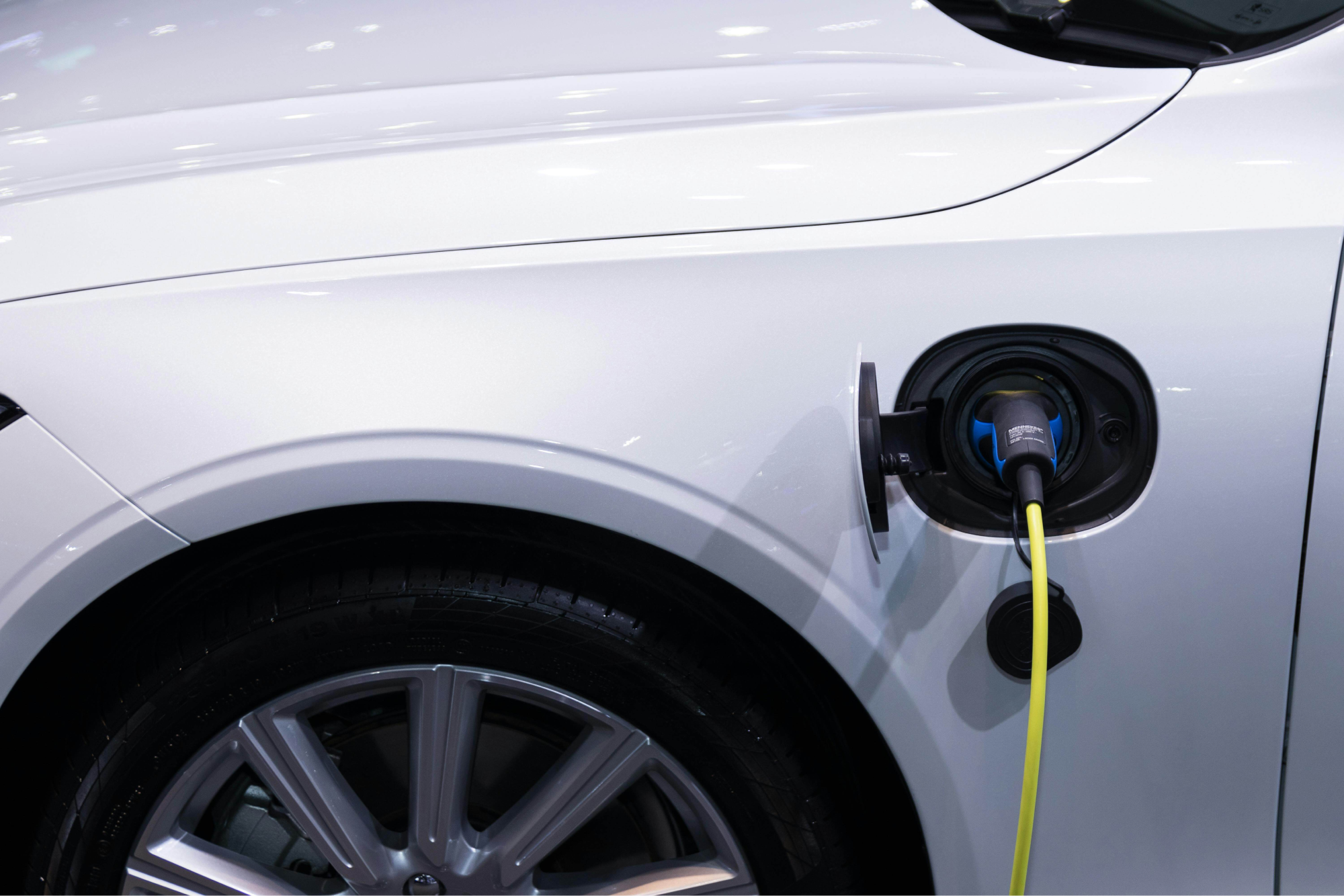 An EV Charger connected to and charging an EV Vehicle