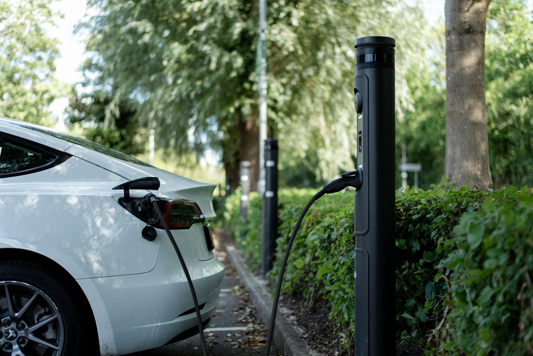 An electric car plugged in at a charger